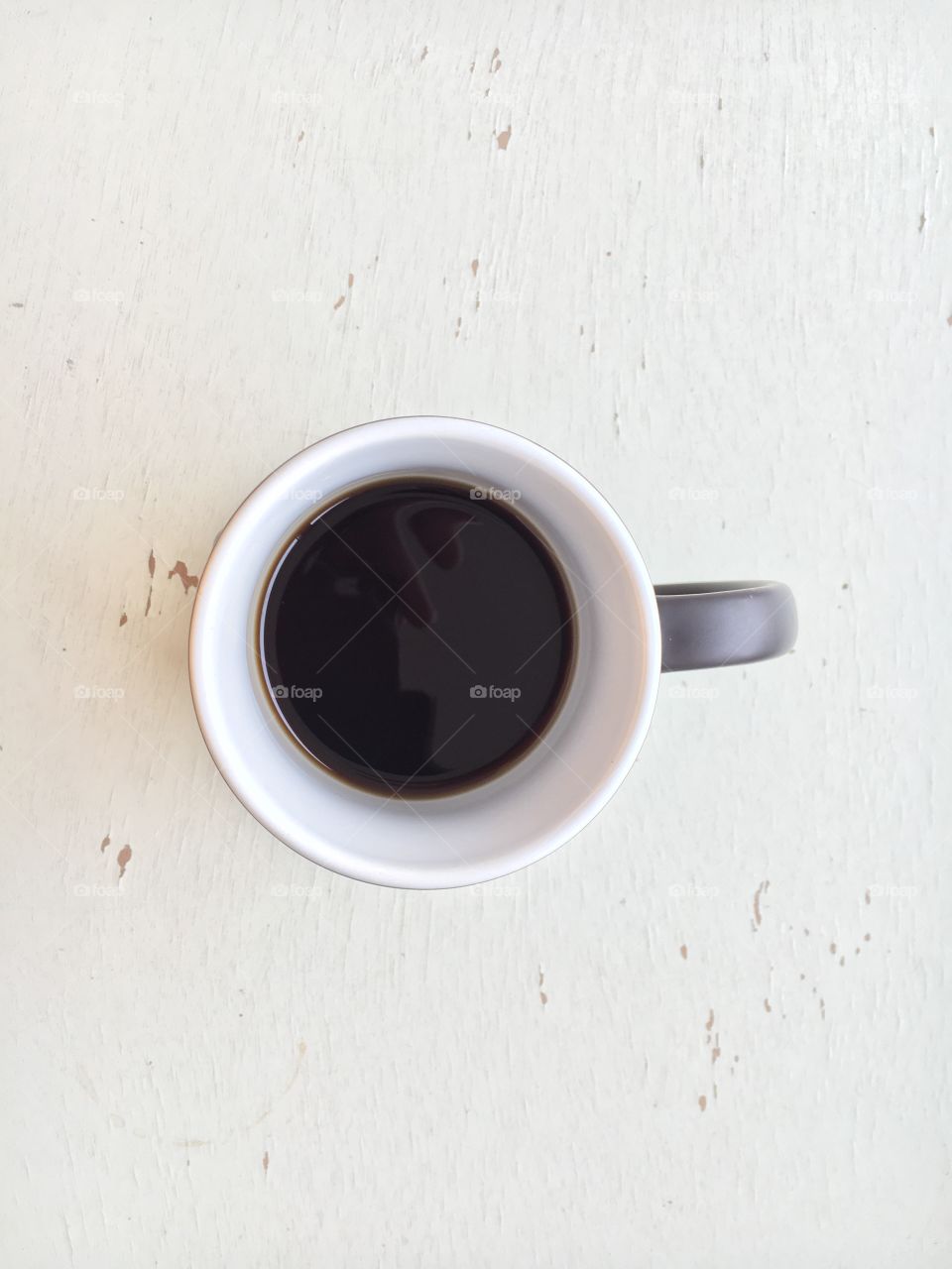 Half Empty Cup of Coffee on an Old Antique Desk in February 2018