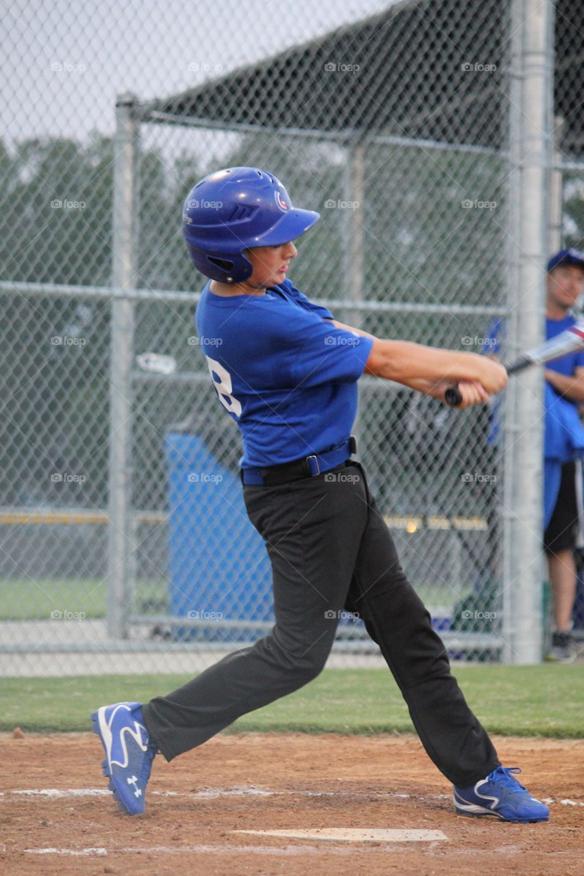 Baseball fever. Boy swinging a baseball bat