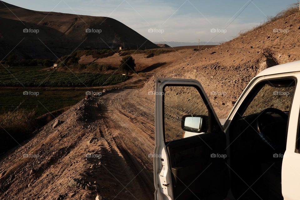 Car gate in front of agricultural field