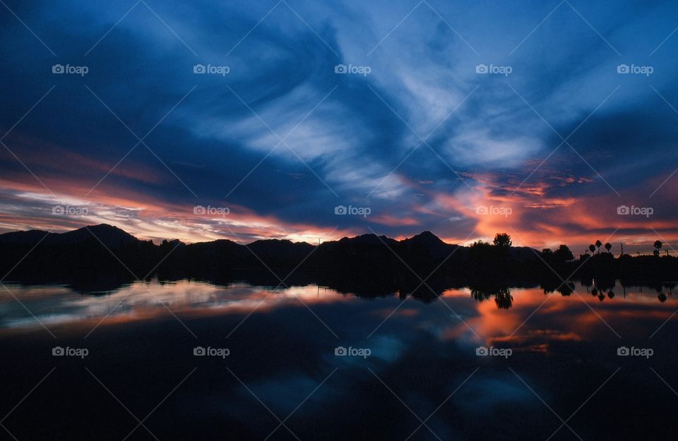 A sunset casts it's reflection onto a pond in Arizona.