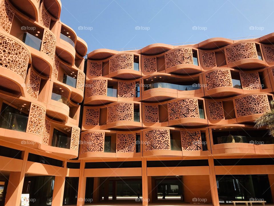 The overall concept of Masdar City promotes features such as smart infrastructure, intelligent building design that reduces water and energy needs, zero-carbon public transportation.