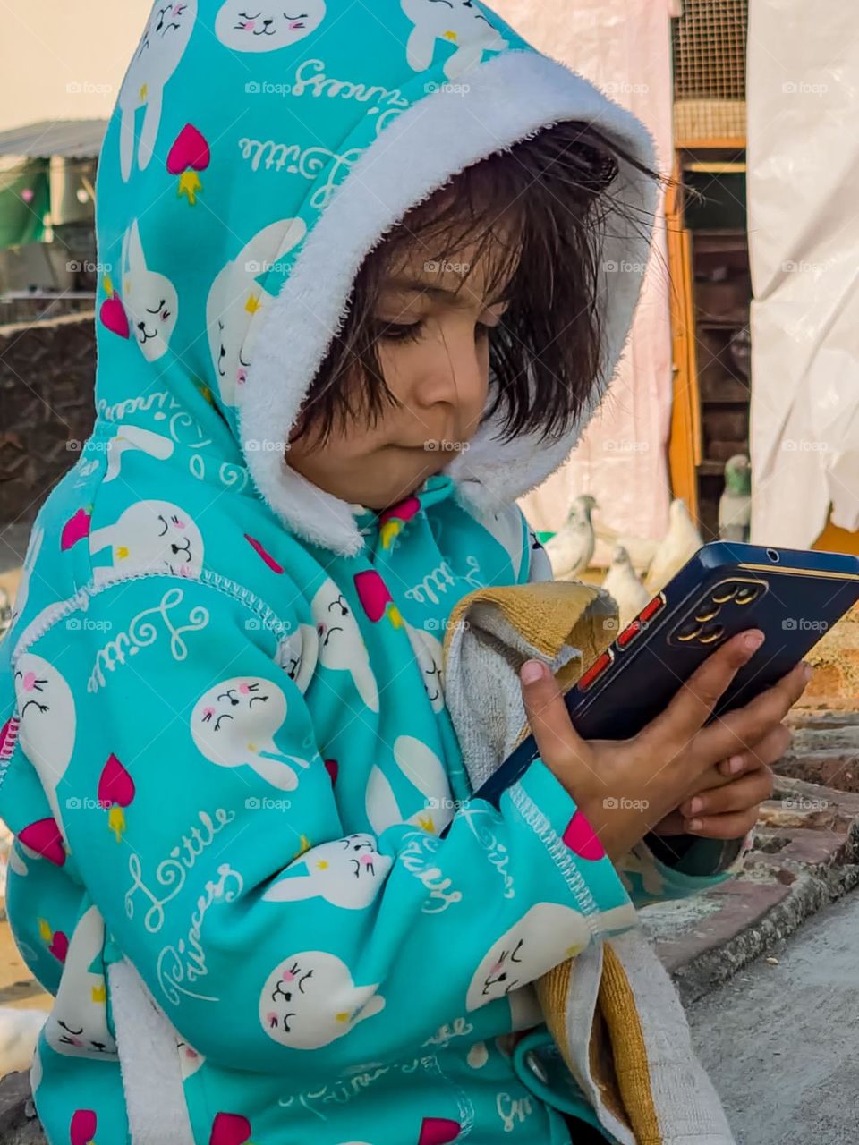 Cute little girl playing with mobile