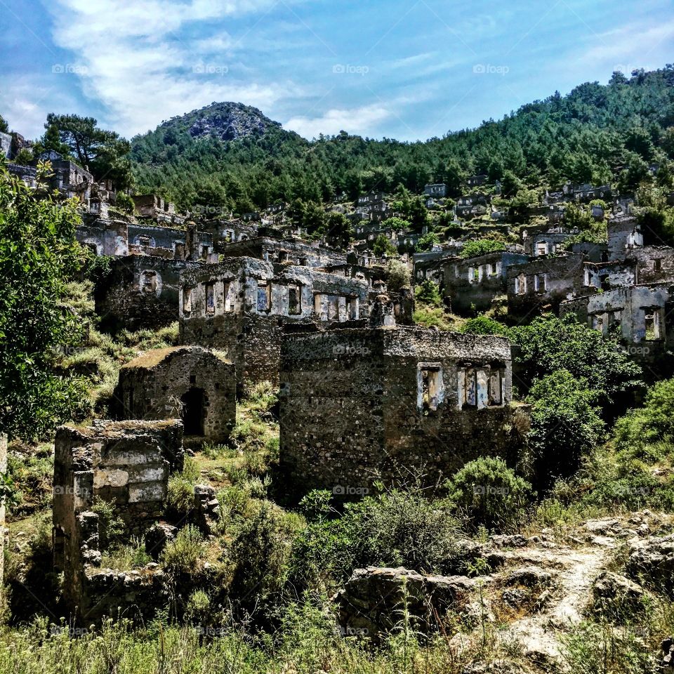Kayakoy Ghost Village, Southern Turkey

Kayaköy, anciently known as Lebessos and Lebessus (Ancient Greek: Λεβέσσος) and later as Livissi (Greek: Λειβίσσι) is a village 8 km south of Fethiye in southwestern Turkey. In ancient times it was a city of Lycia, Later, Anatolian Greeks lived there until approximately 1922. The ghost town, now preserved as a museum village, consists of hundreds of rundown but still mostly standing Greek-style houses and churches which cover a small mountainside and serve as a stopping place for tourists visiting Fethiye and nearby Ölüdeniz.