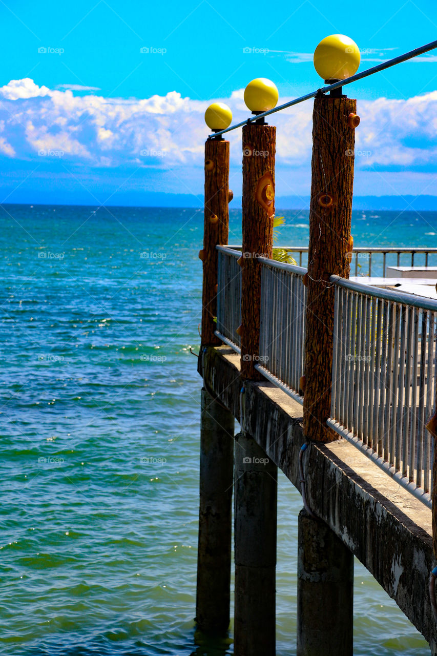 Three wooden post in the beach.