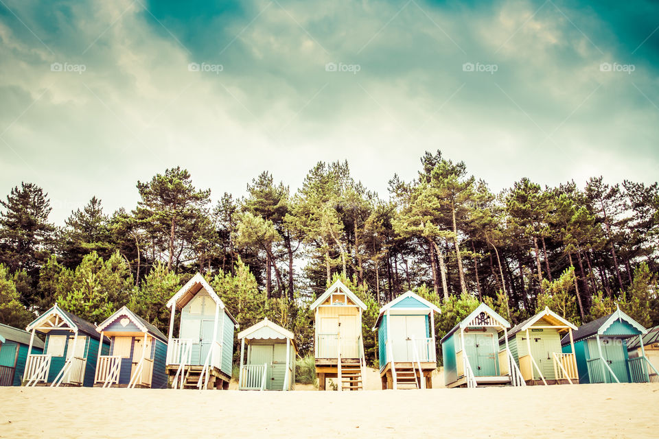 Rows of beach huts on the sandy beach at Wells Next The Sea in Norfolk, UK