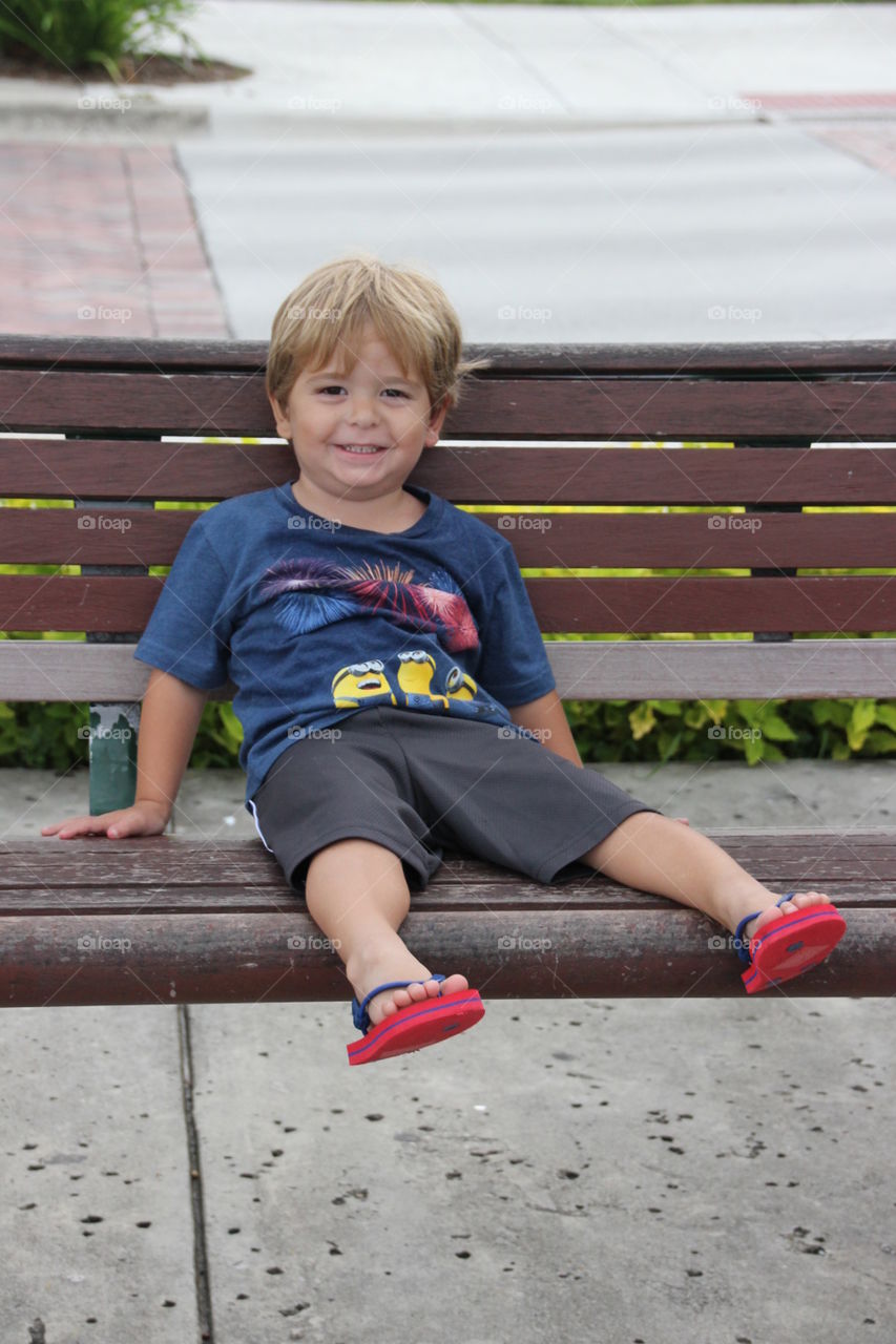 Relaxed child on a bench