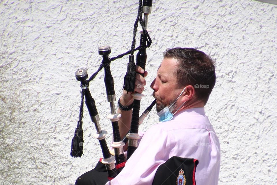 Man is playing an bagpipes