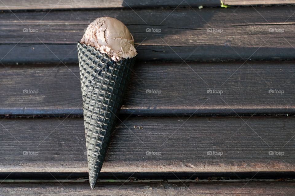 Brown ice cream on brown bench 