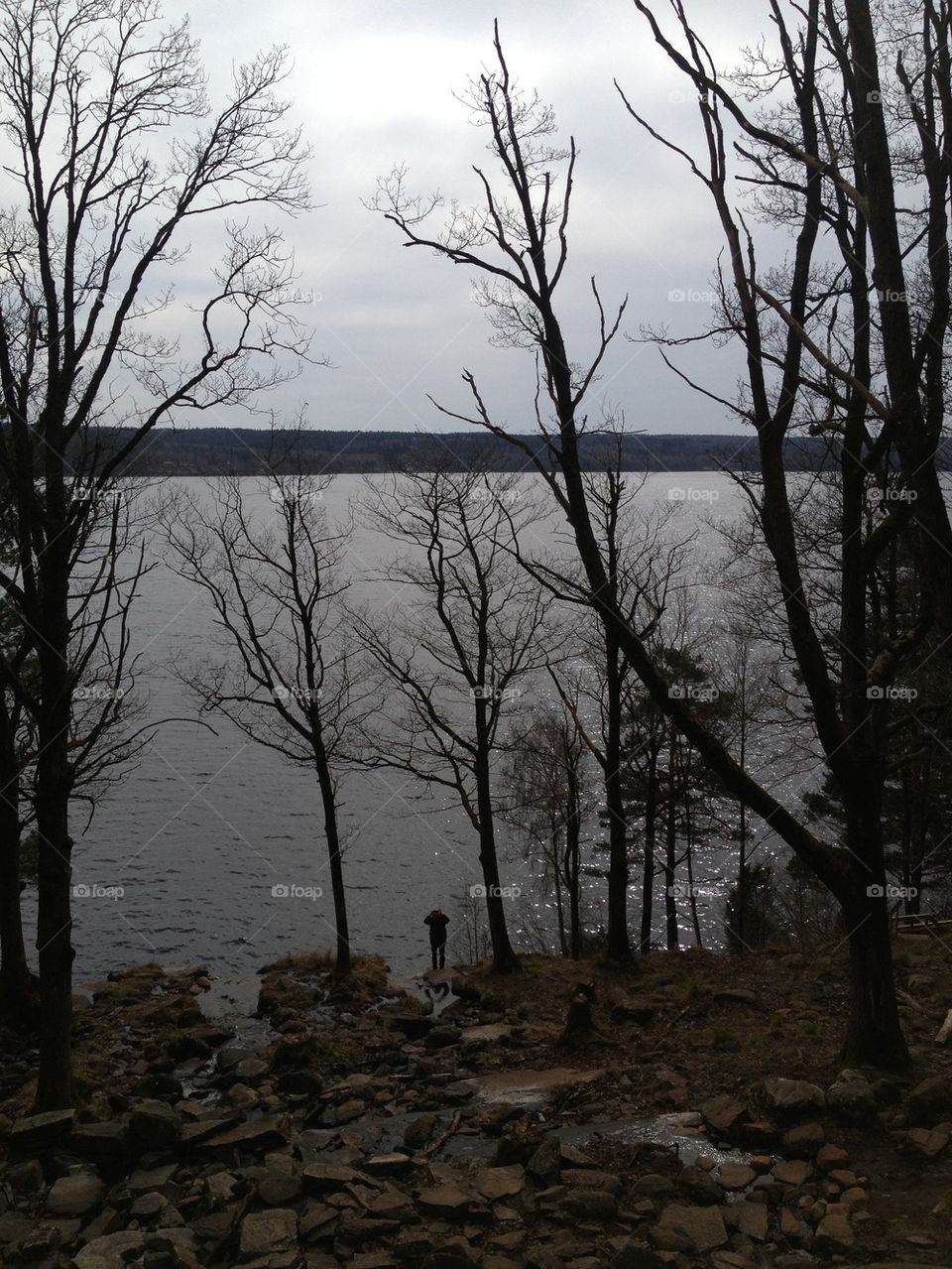 Silhouette of a man at a lake