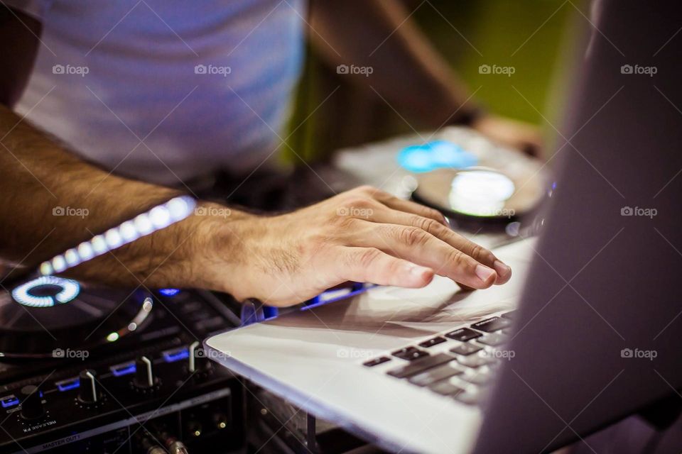 macro photo of a male hand working at a computer and remote control