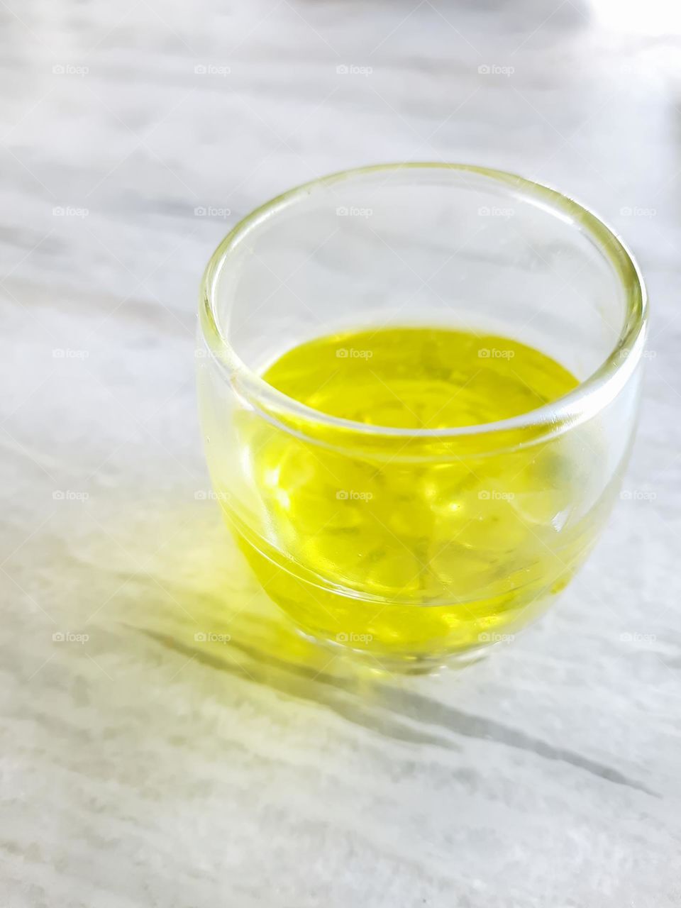 Yellow Colored Juice on a white textured background