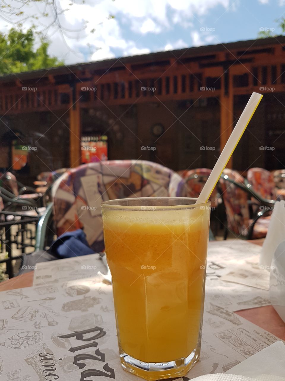 fresh orange juice in the glass on the table