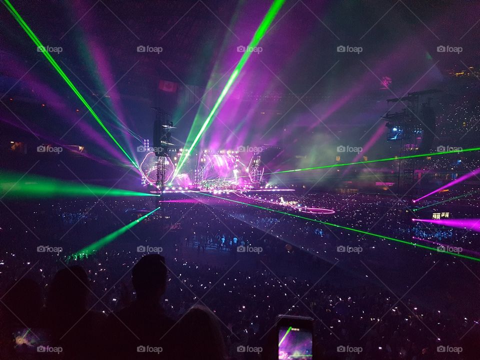 Enjoying a bright light show from a Coldplay concert in Toronto. Neon lights express the beats of the music.