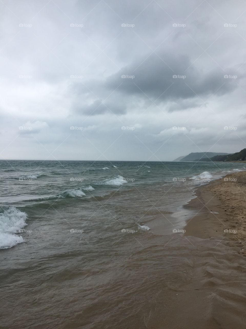 Lake Michigan cloudy beach. View of Sleeping Bear Dune along Lake MI on a grey and cloudy day 