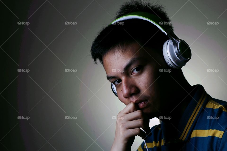 Portrait of a boy listening music on headphones