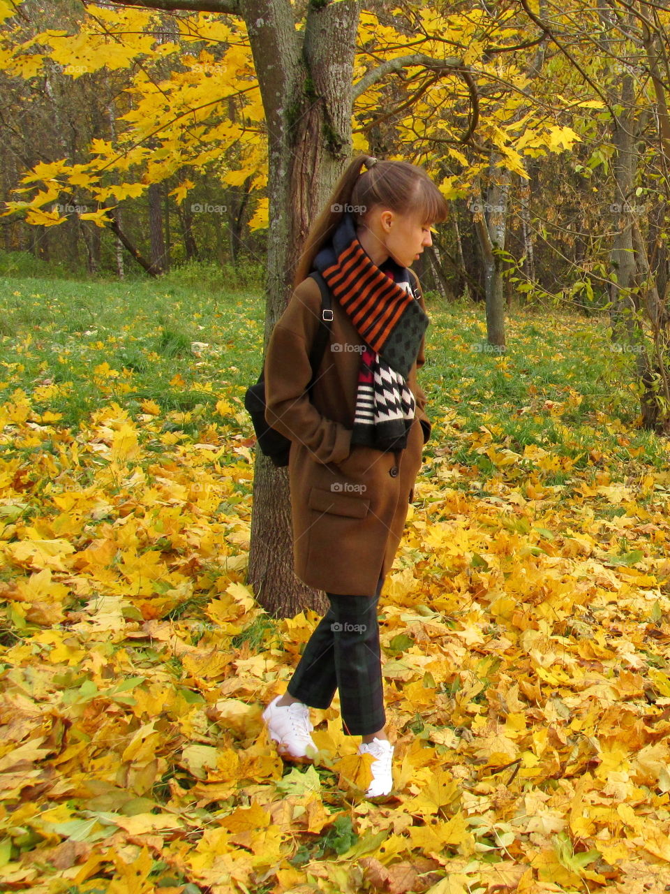 sweater weather. a walk in the park in a warm coat and a knitted scarf