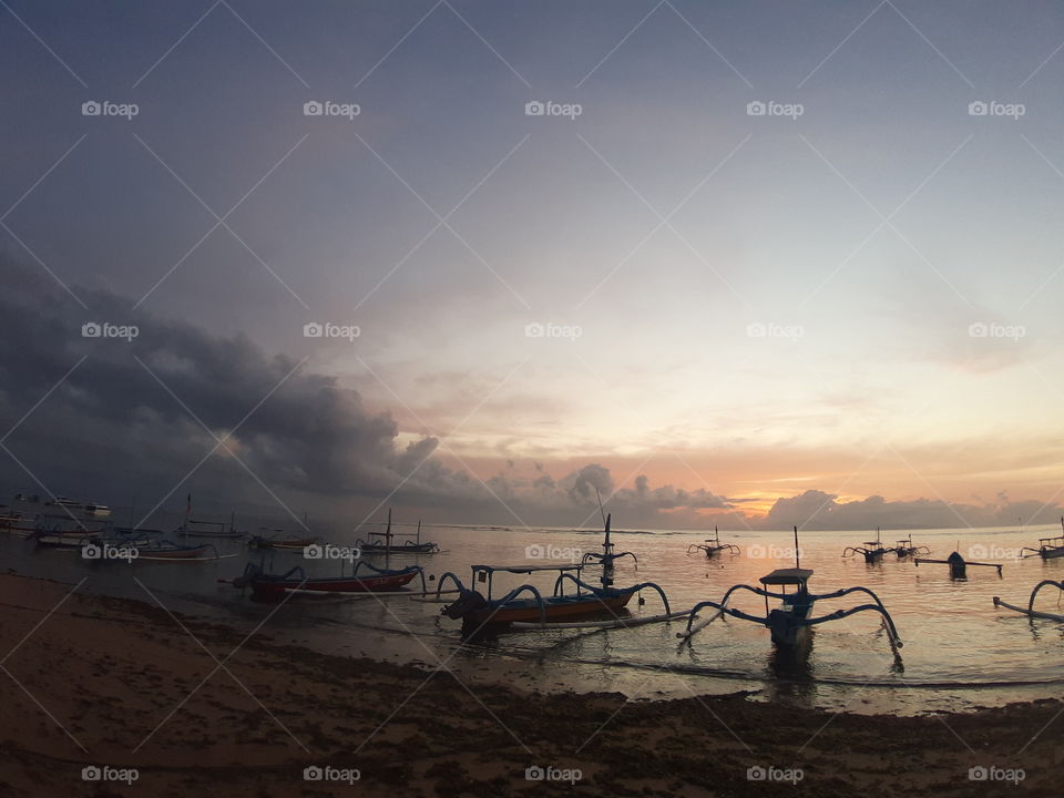 Morning view on the beach where the fishing boats is parked