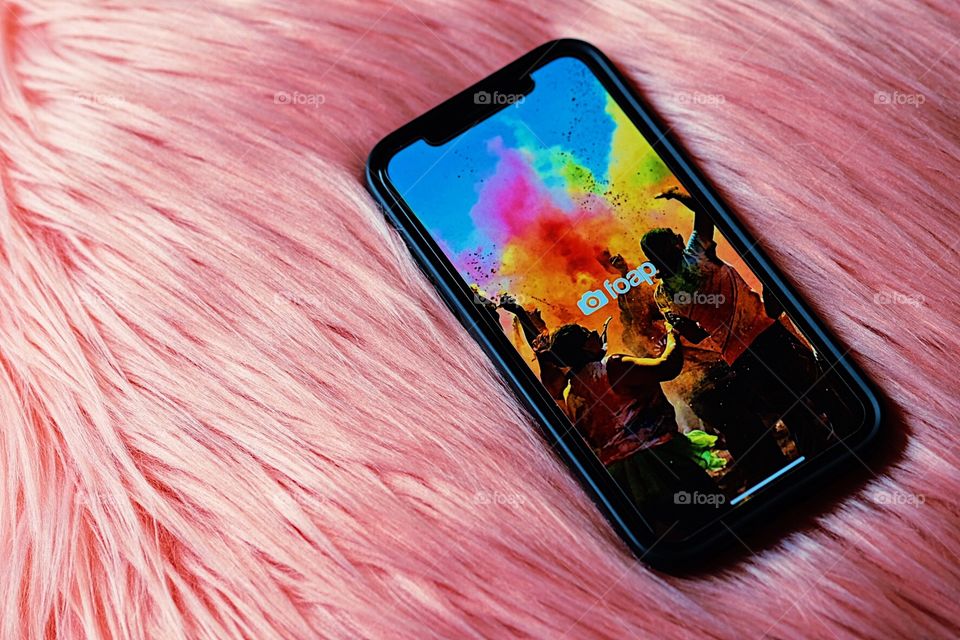 Foap app on cell phone, using the Foap app on iPhone, pink furry pillow with Foap app, relaxing with Foap, working from home, working from home with Foap, using Foap to earn money, making money on photography, my photos making money, Foap app