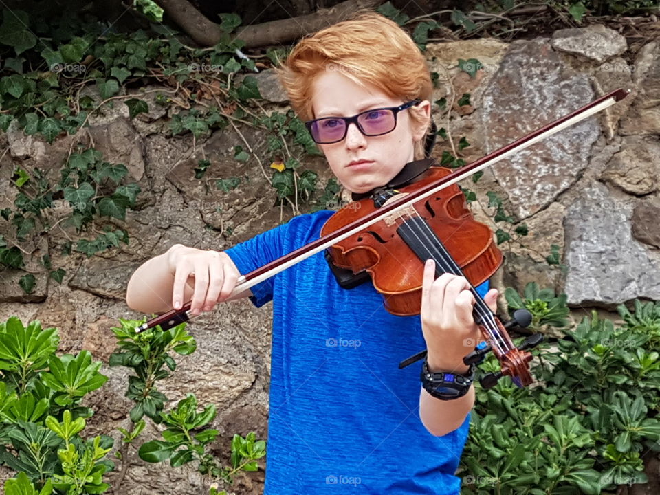 violinist played in hand barcelona spain park guell  violin instrument music