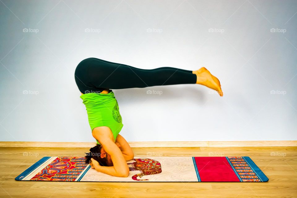 A beautiful slim girl takes care of her health and practices yoga every day.