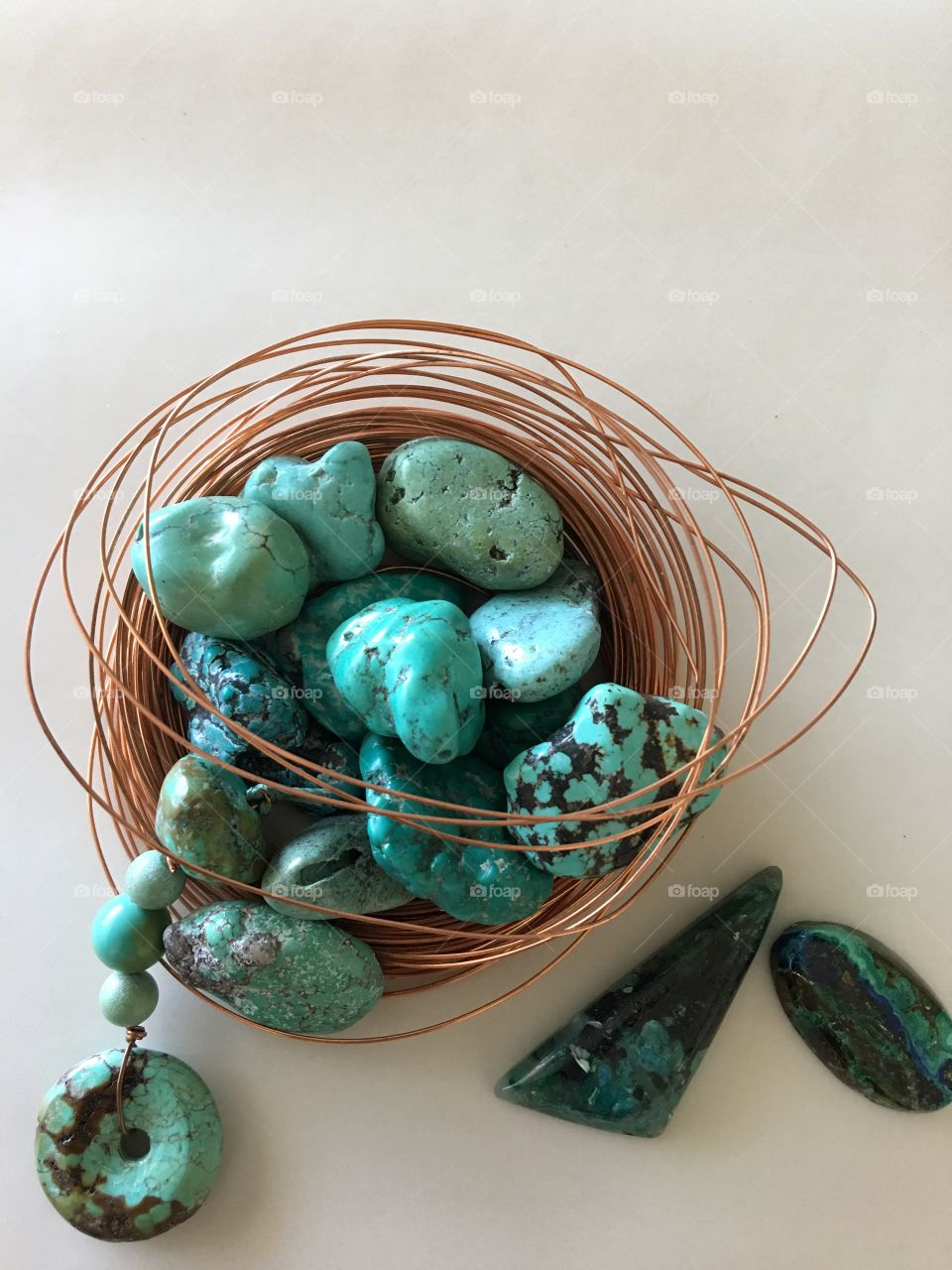 Turquoise stones in nest of copper wire