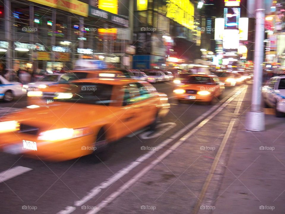taxis flying by in new york city