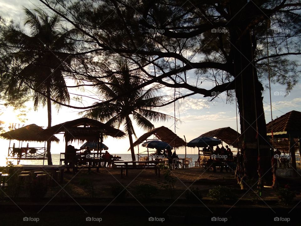enjoying fresh coconut juice at manikar beach labuan island