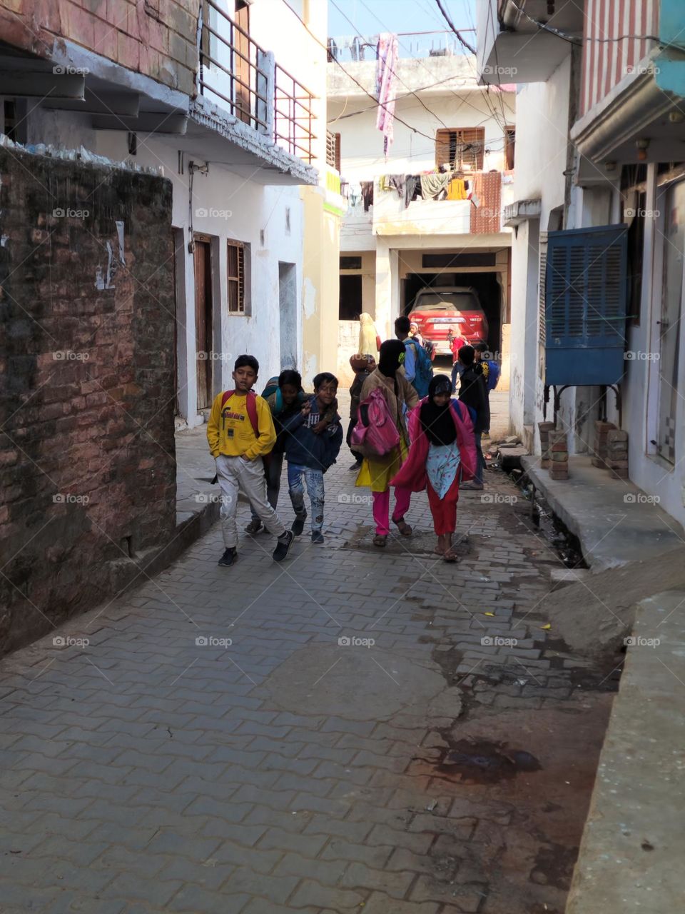 Children walking on street going back home happily