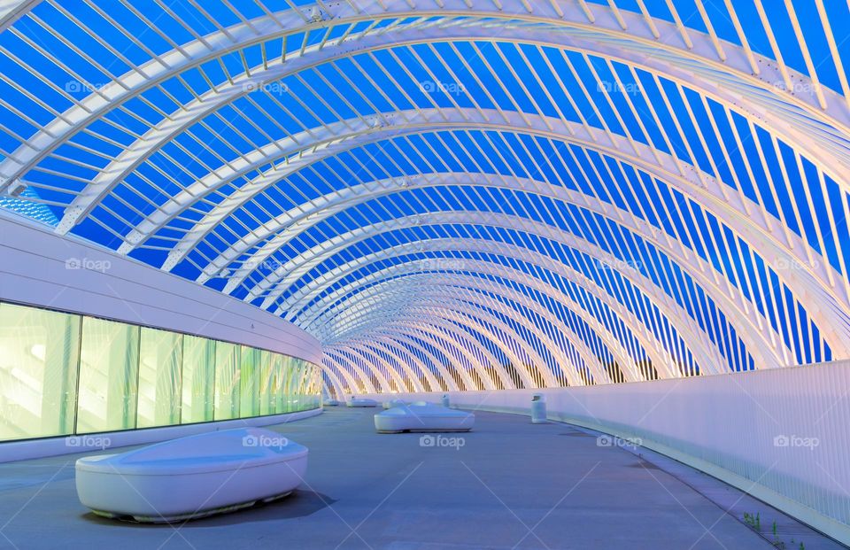 beautiful architecture details with straight lines, curves, and arches all accented by the lights of the building and the blue evening sky