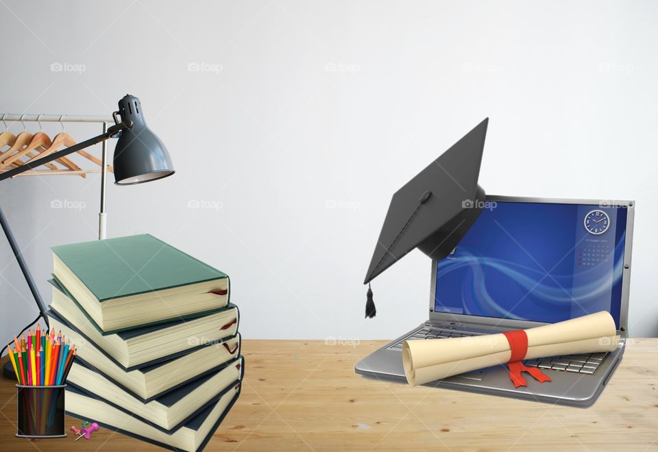 desk picture with laptop and books for educational purpose