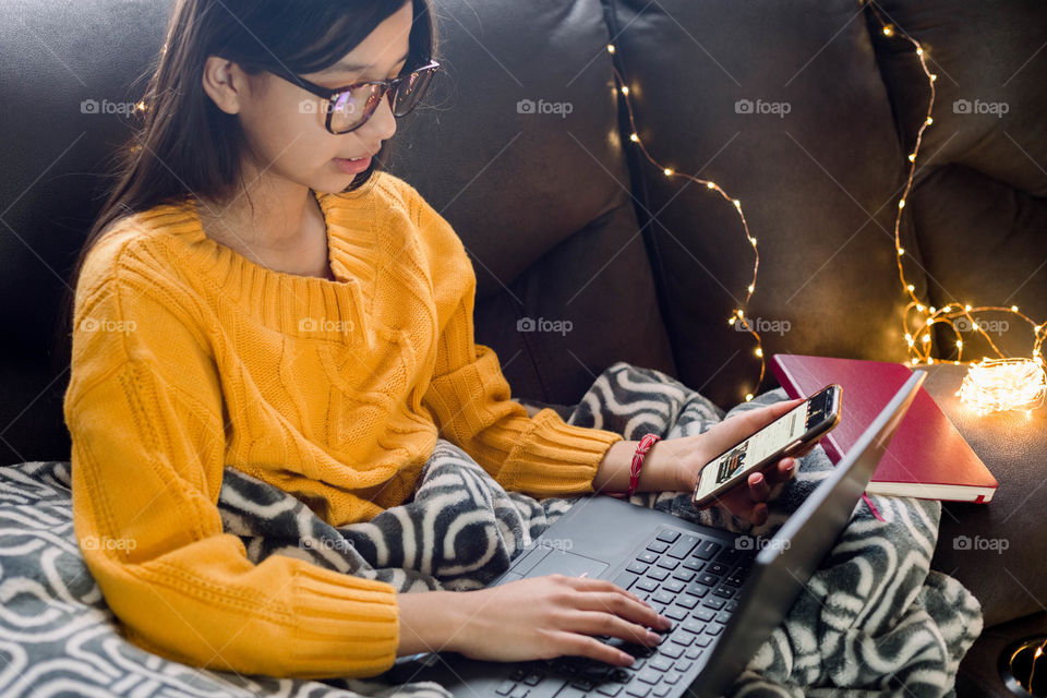 Girl on phone and laptop