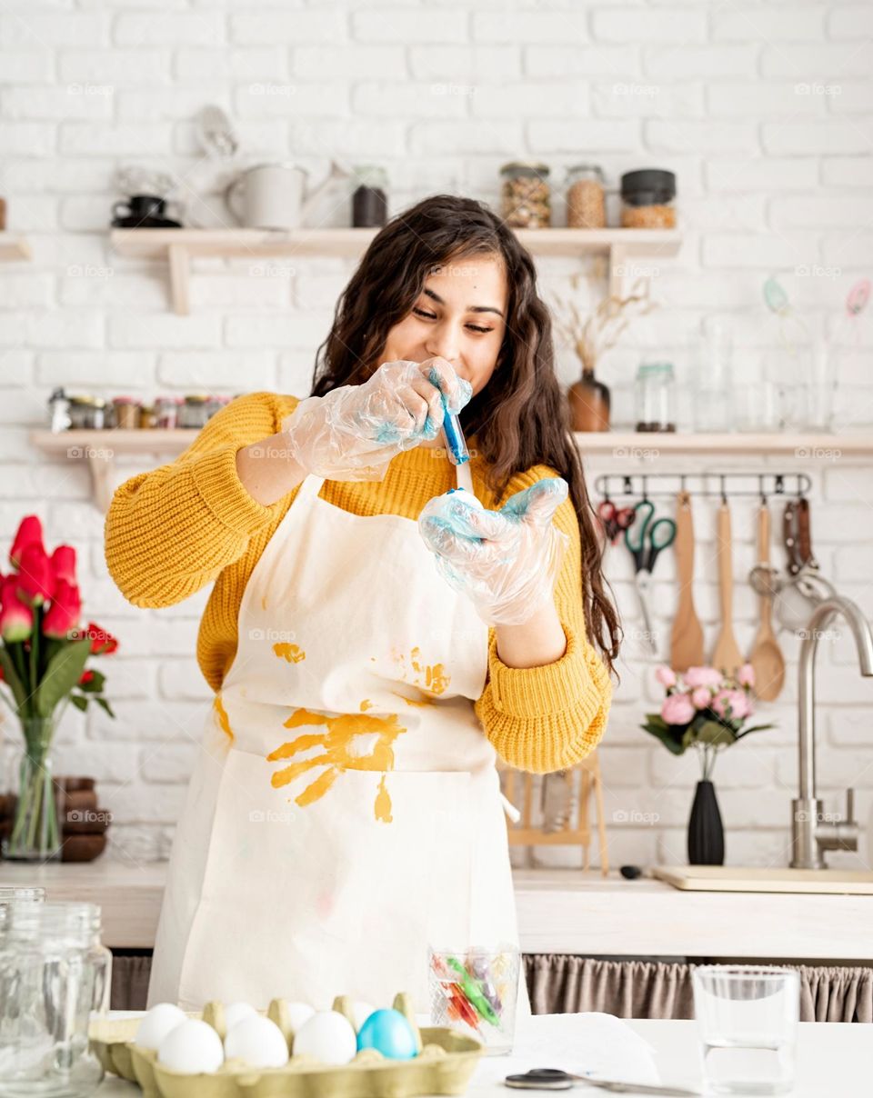 Easter scene woman coloring eggs at home