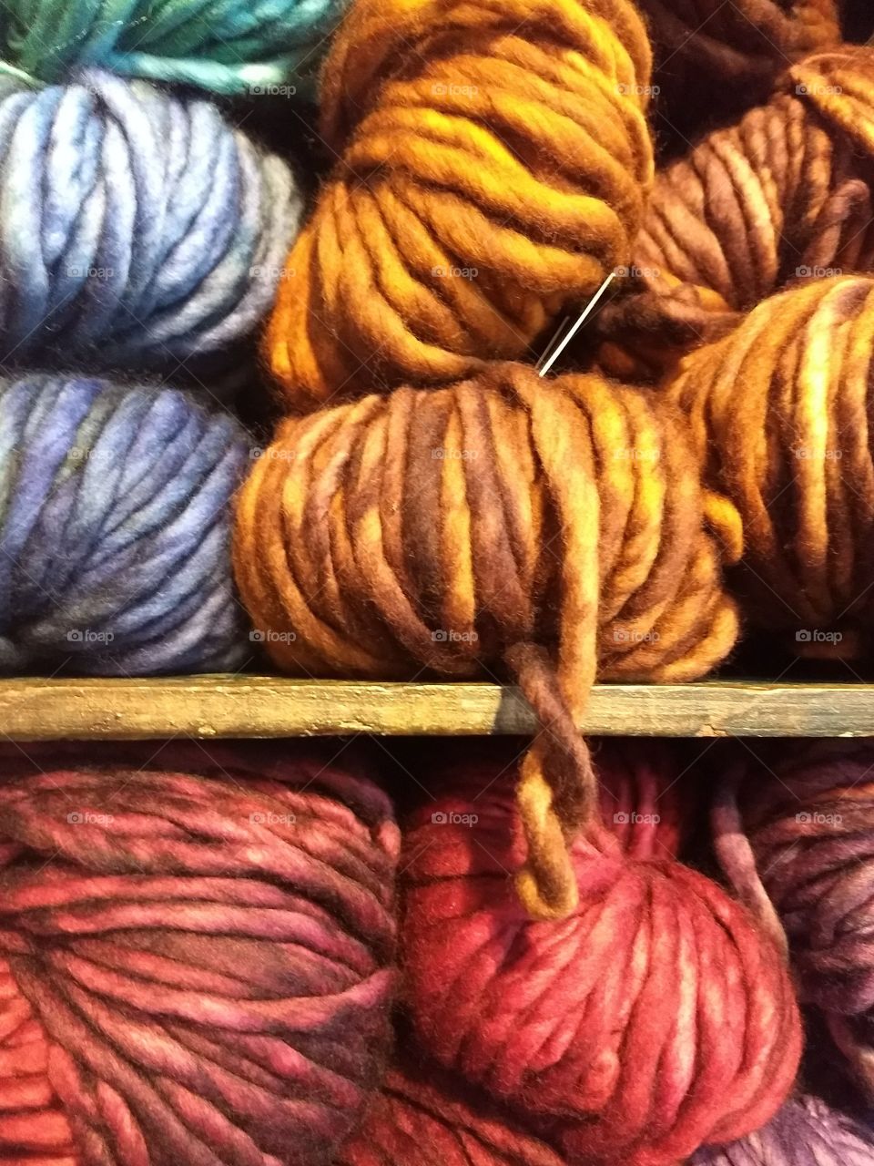 Colorful skeins of yarn on display in a fabric shop.