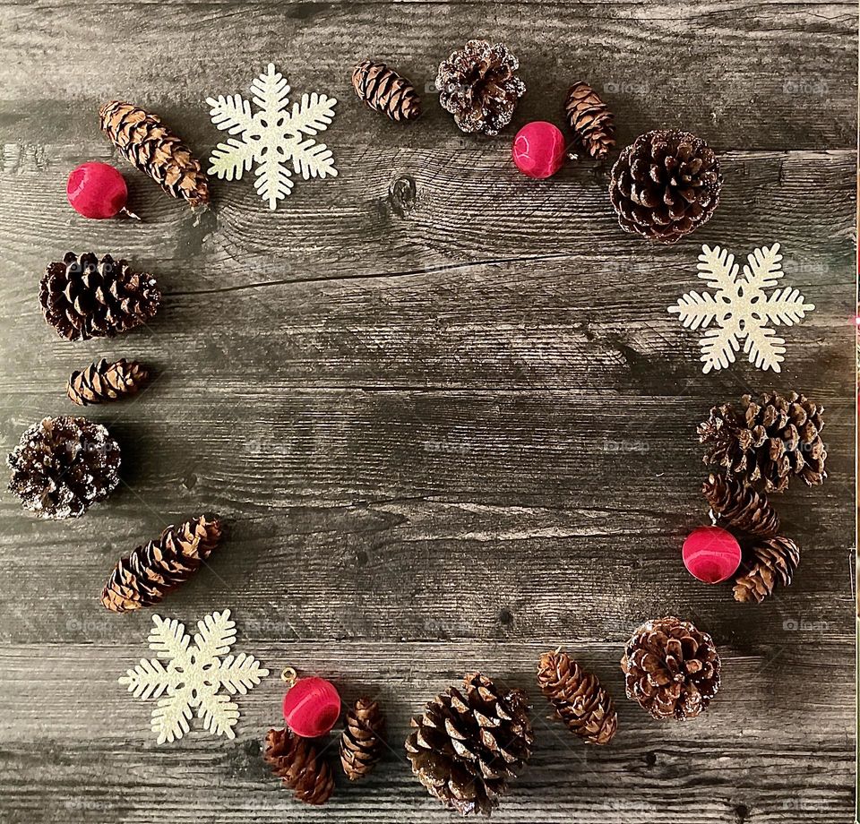 Winter holiday flat lay, pinecones, snowflakes, red ornaments