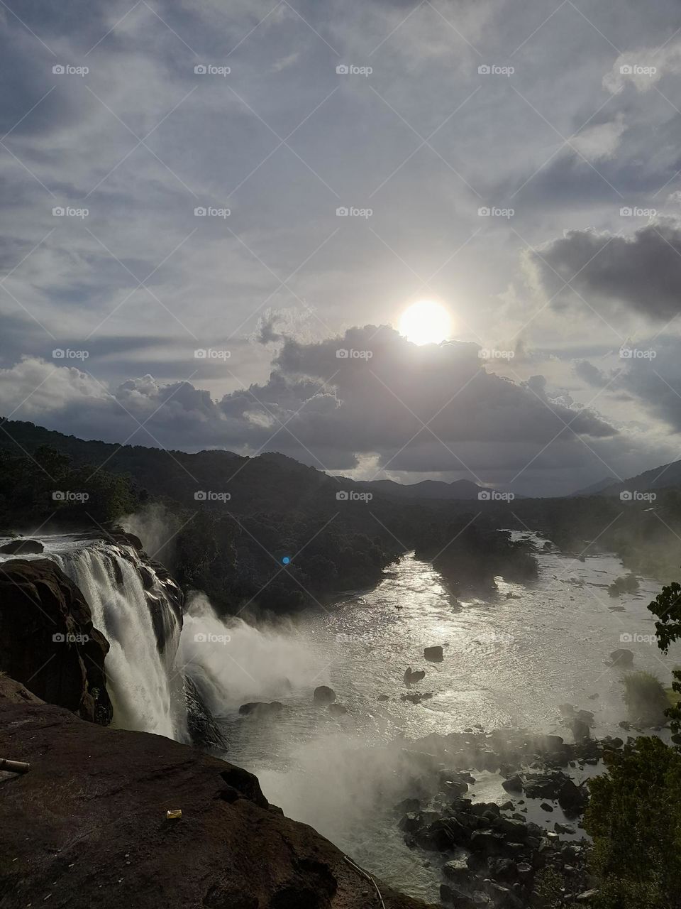 Sunset at the Athirapally waterfalls in Trissur, Kerala India. This picture can be used for the promotion of the tour and travel. A whole day can be spent here.