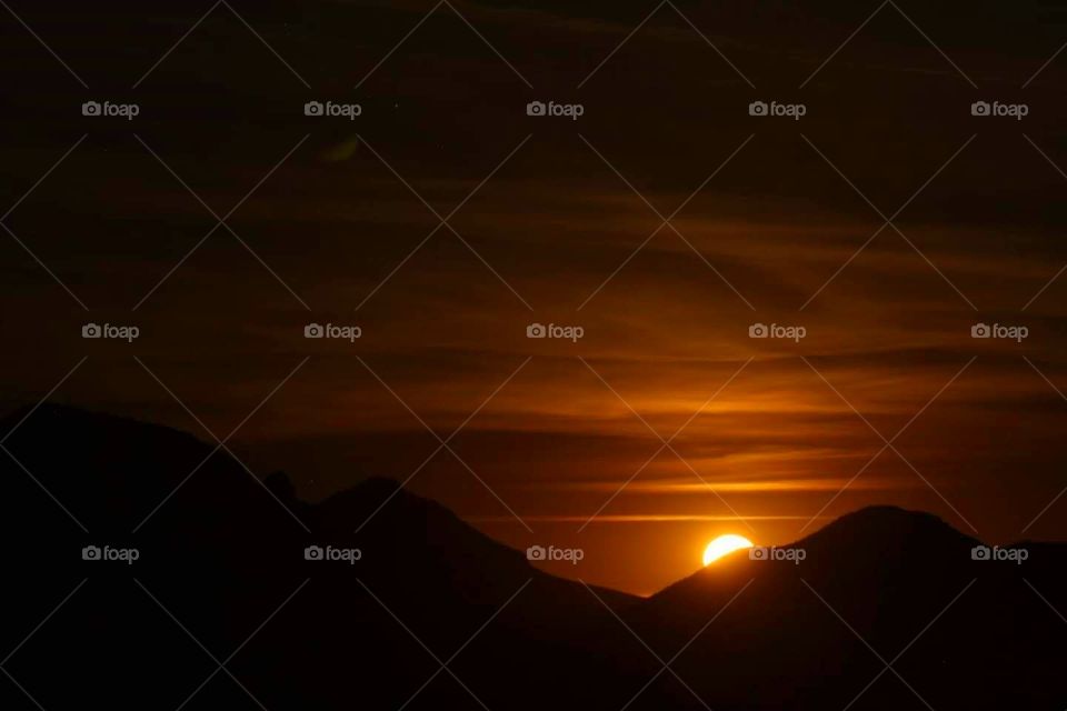 Moon coming up by over the mountains