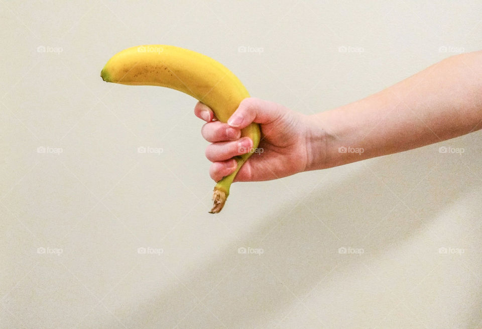 Studio shot of banana in hand