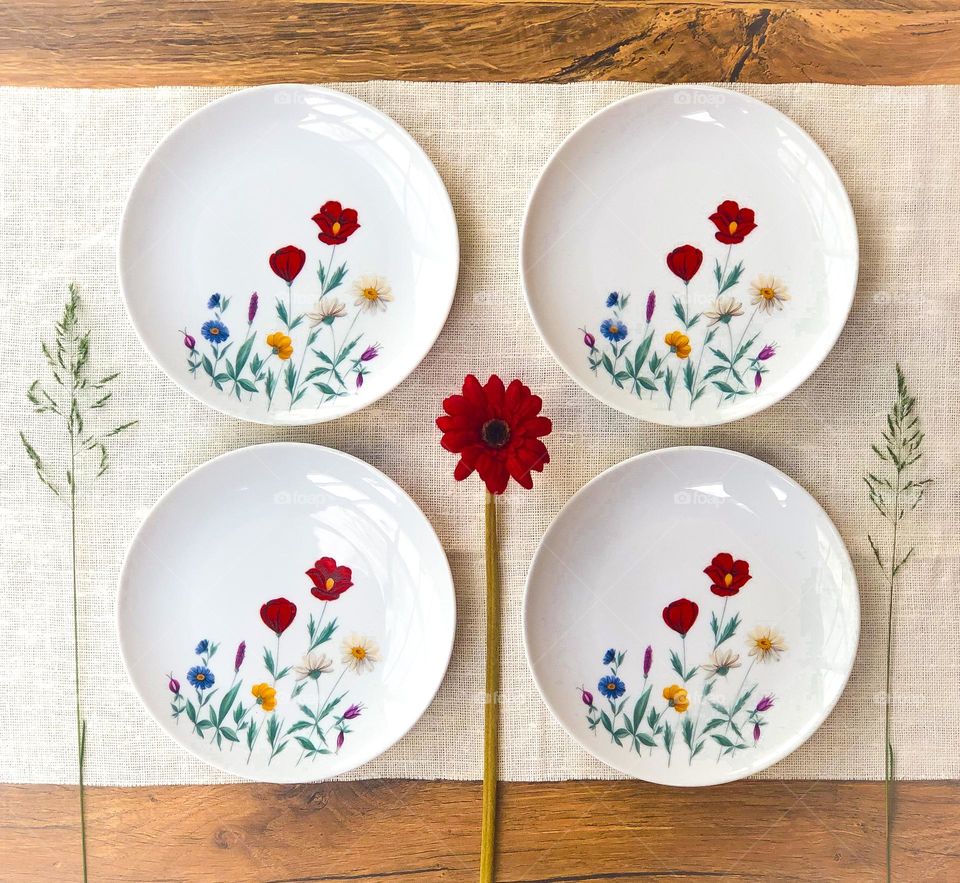 Old porcelain plates with poppies and meadow flowers