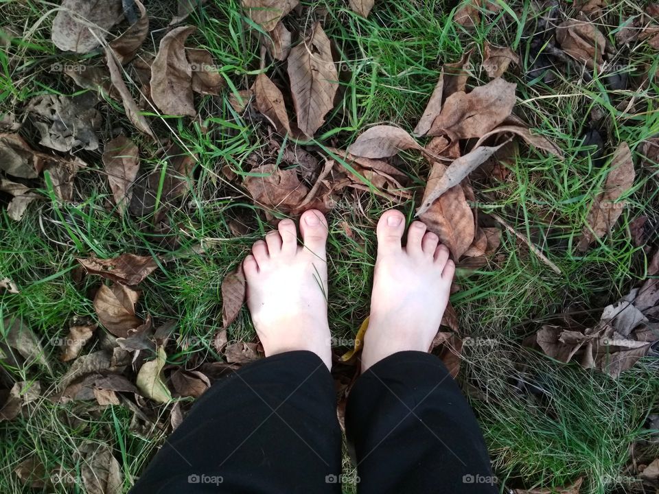 Barefoot on autumn leaves