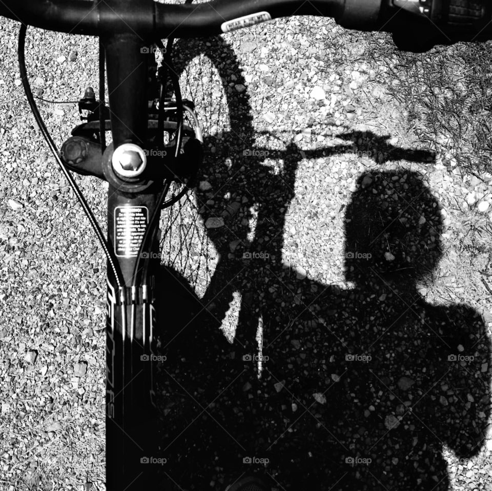 Shadow of a woman on a bicycle in black and white