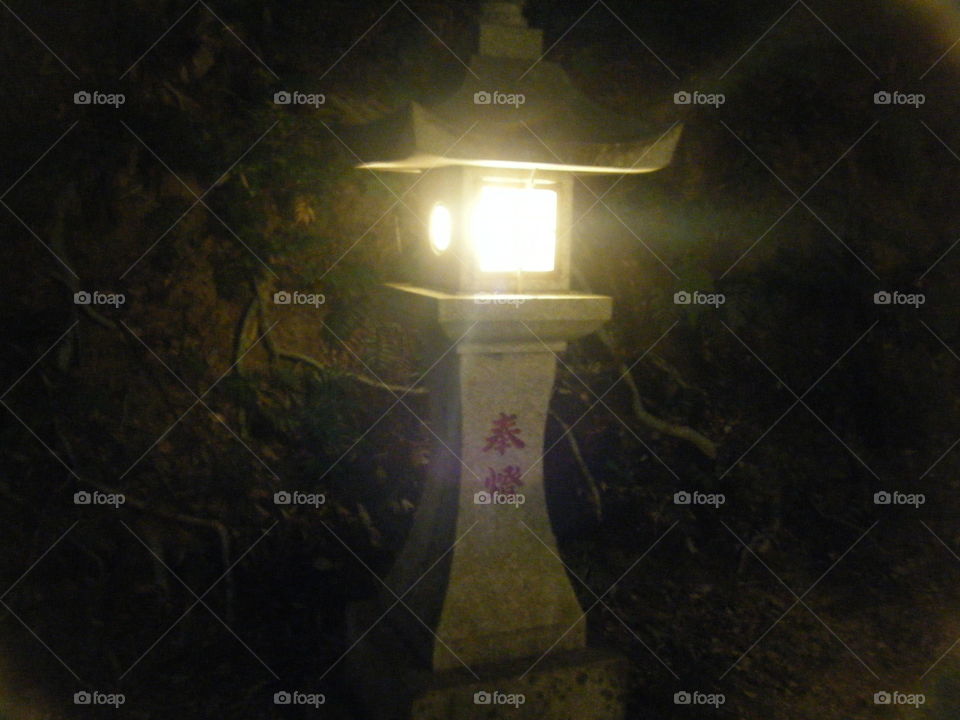 Shrine's lit night lantern.