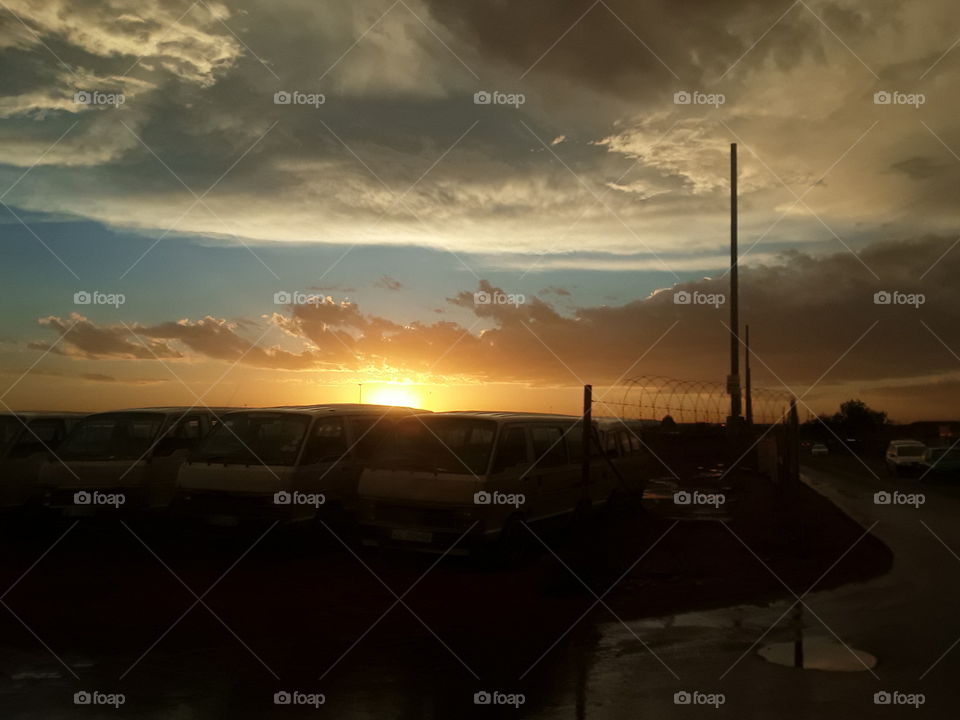 Evening skies and the cloudy weather conditions.