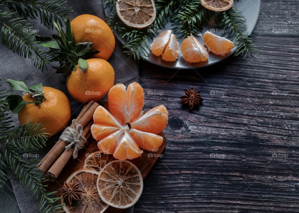 Flatlay mandarin orange cinnamon and Christmas tree branches 