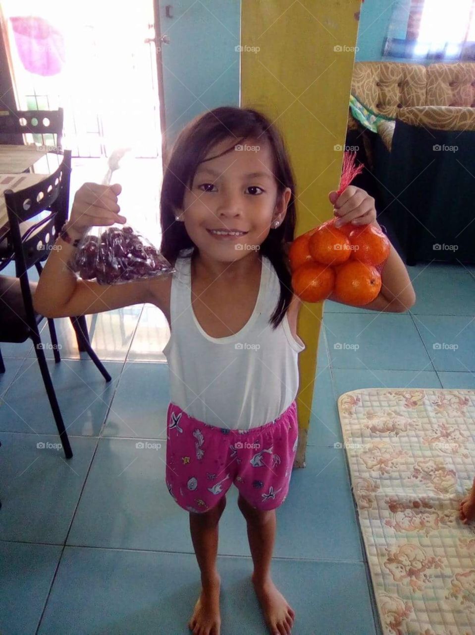 One of our children eating healthily today with grapes and oranges.