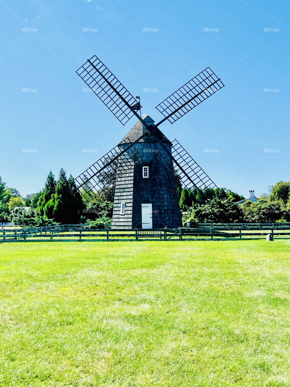 This rural landscape is graced with this historic wooden windmill that dates back to the 1800s.  Once considered  farm equipments they are now regarded  as graceful and charming relics.