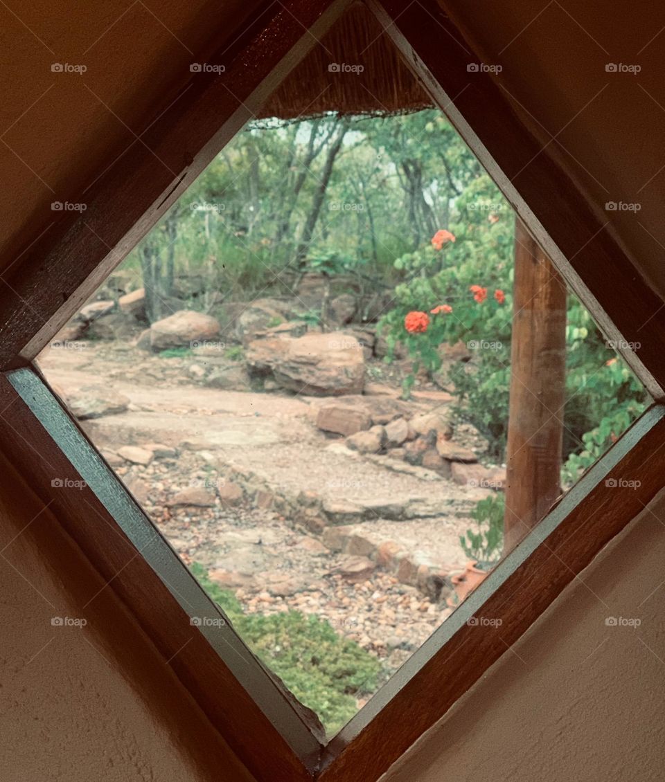 Diamond shaped Wooden Windowsill. House made of rocks and wood. 🪟