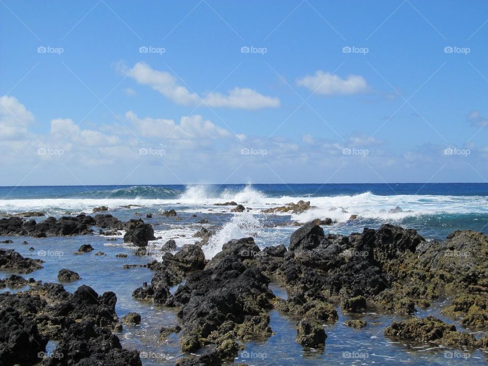 Waves breaking into rocks