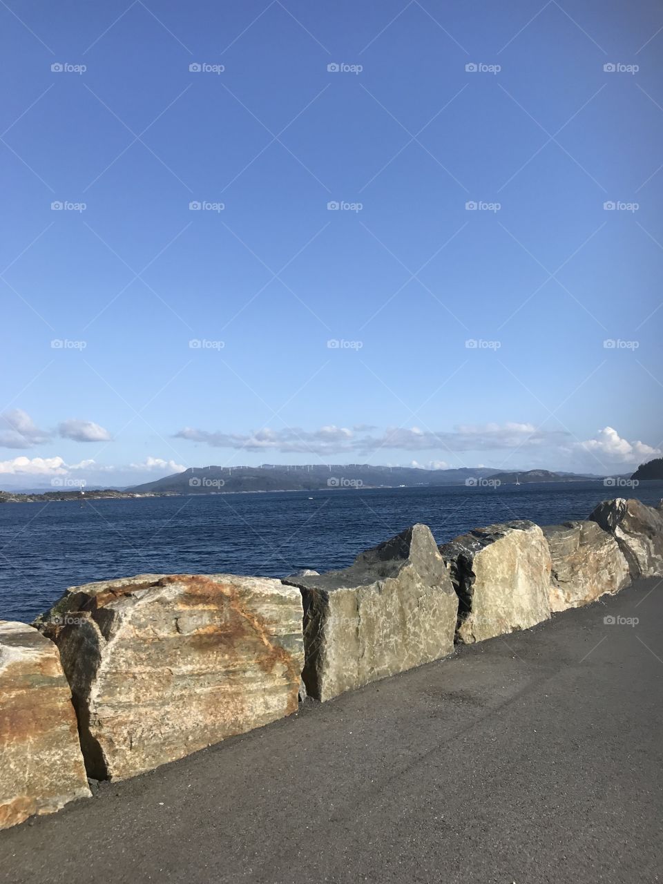 Picture taken from Bekkjarvik in Austevoll in Norway. In the background there is many windmills.