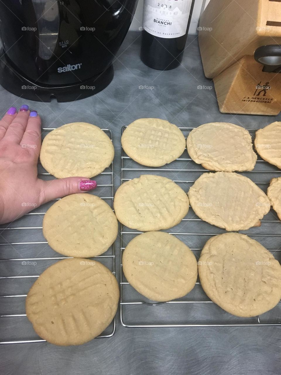 Middle aged lady showing how big her cookies are with thumb and pointer fingers