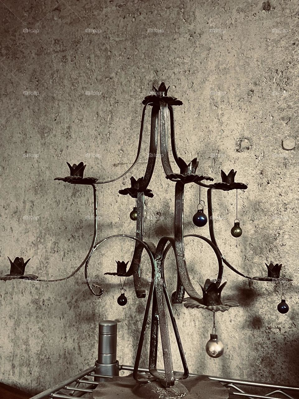 Antique metal candle holder with ornaments.